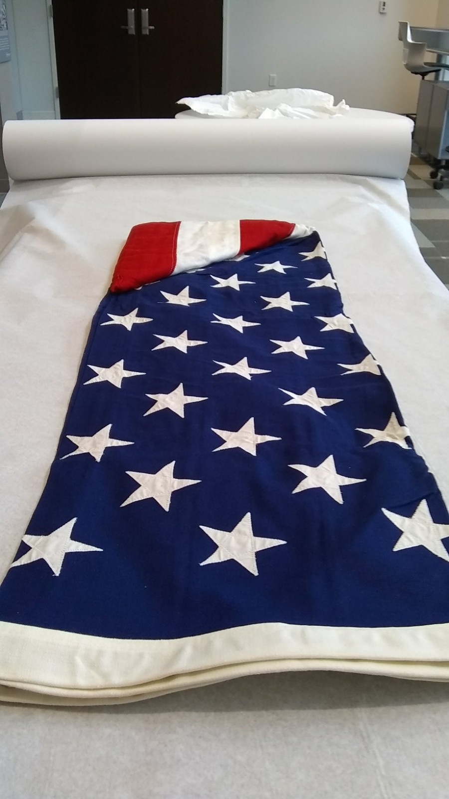 U.S. flag, gifted to the AOA by the Armed Forces Optometric Society in 1970, lays unfolded to be inspected.